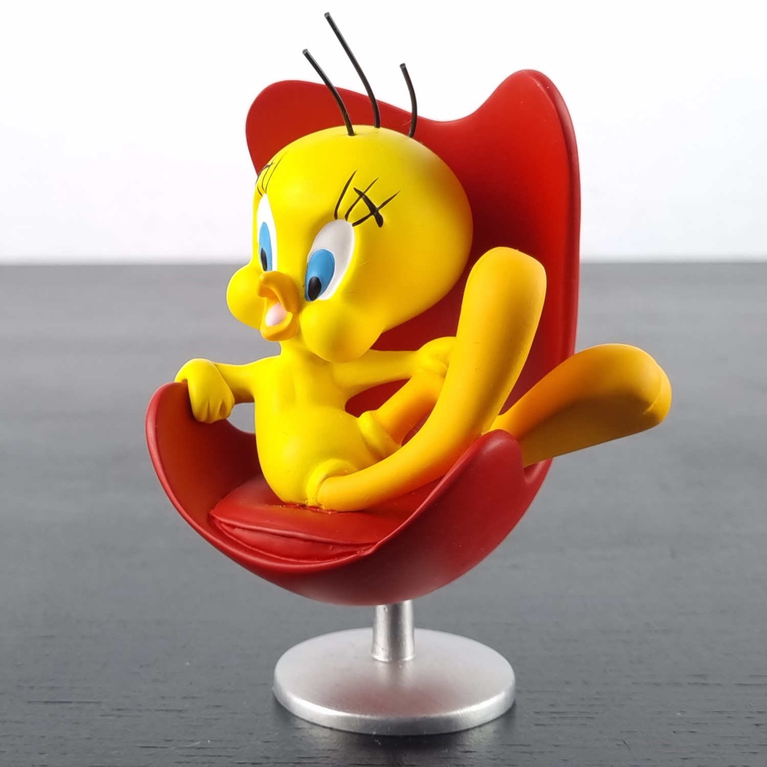 Tweety Bird sitting in a red chair figurine _left front