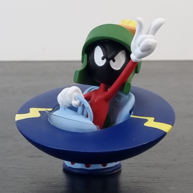 Marvin the Martian UFO flying his figurine _left front