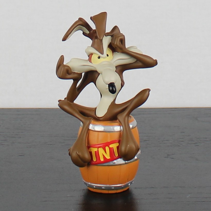 Wile E Coyote sitting on a TNT barrel figurine